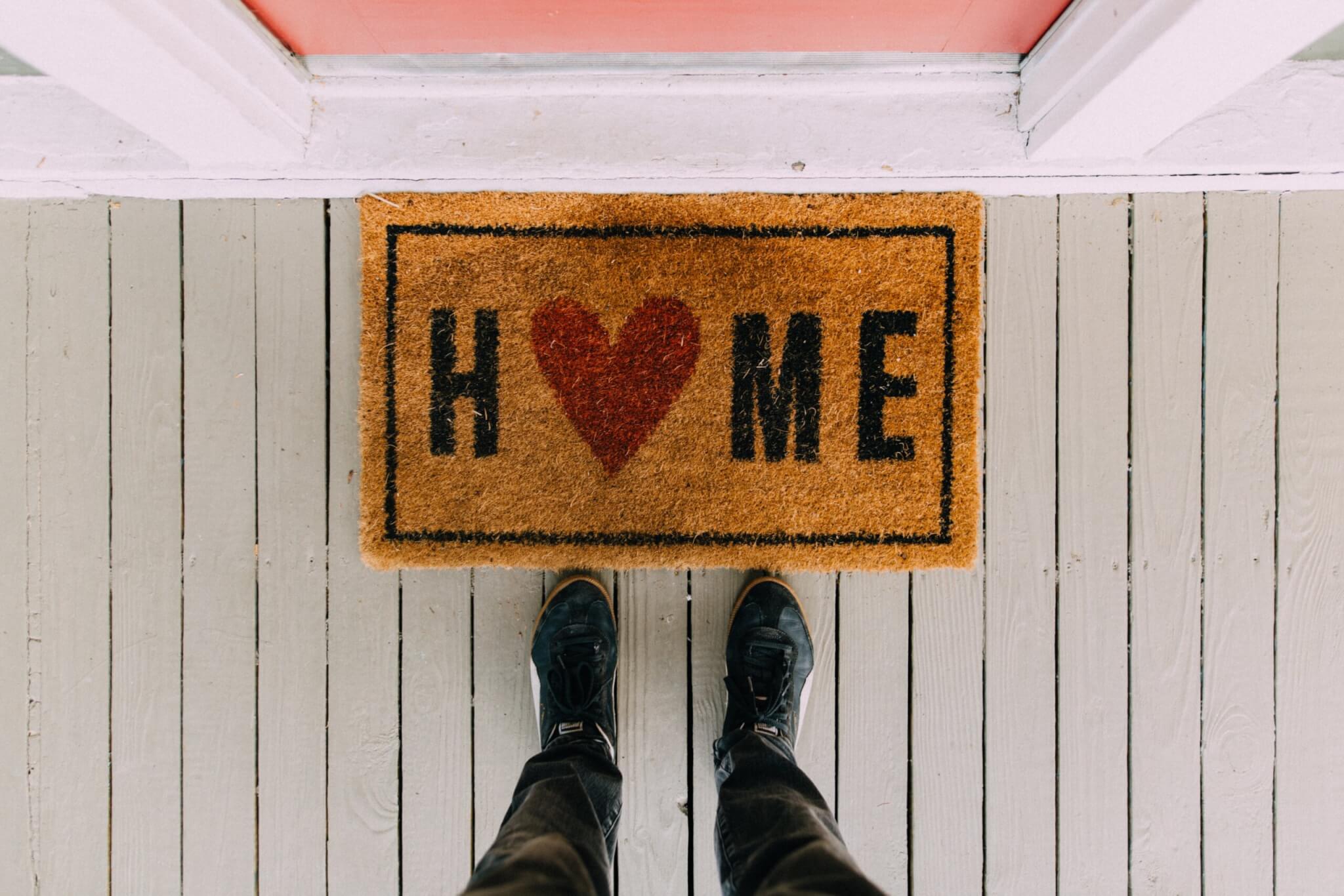welcome mat in front of house