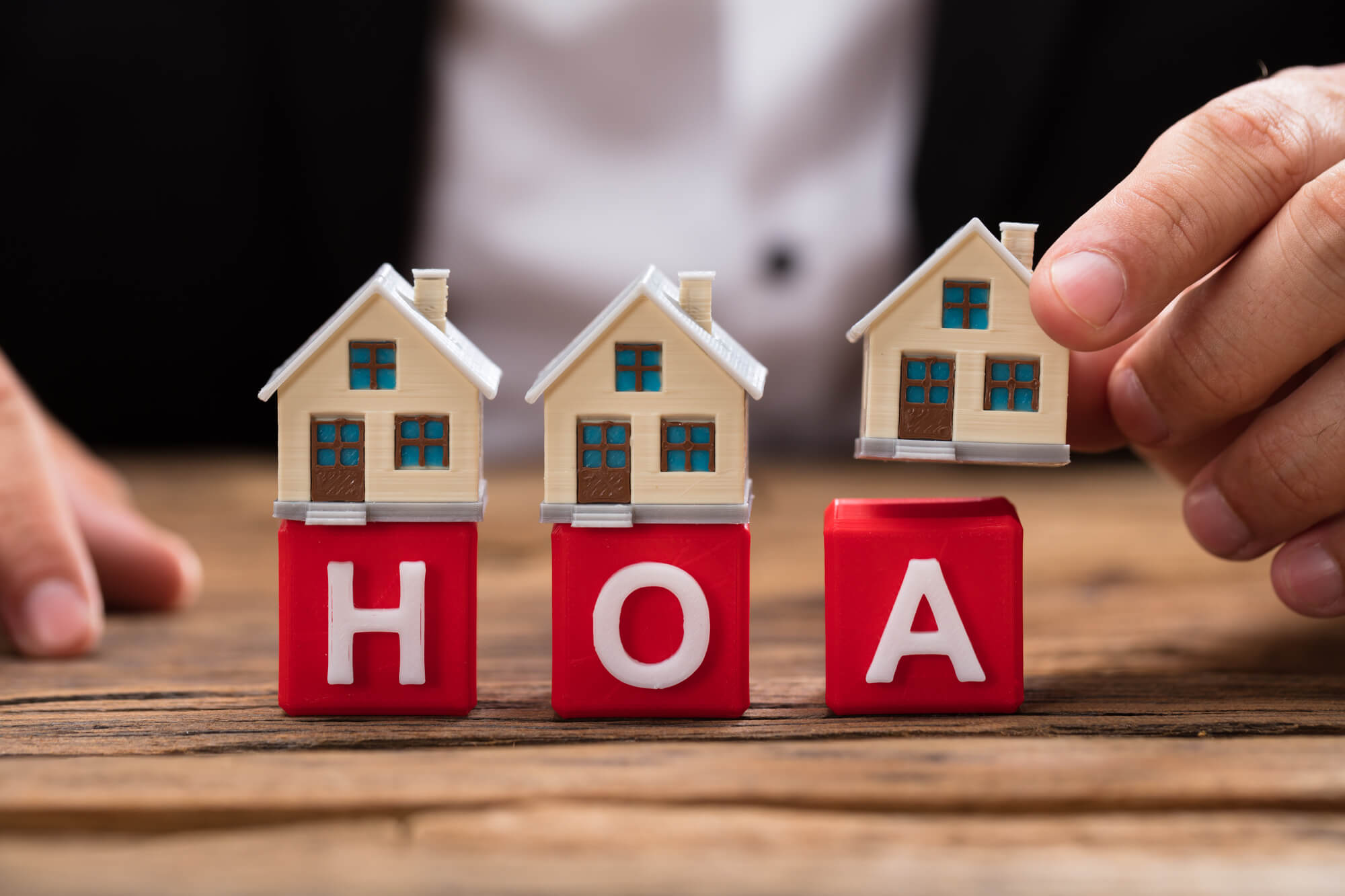 toy houses on blocks spelling out HOA